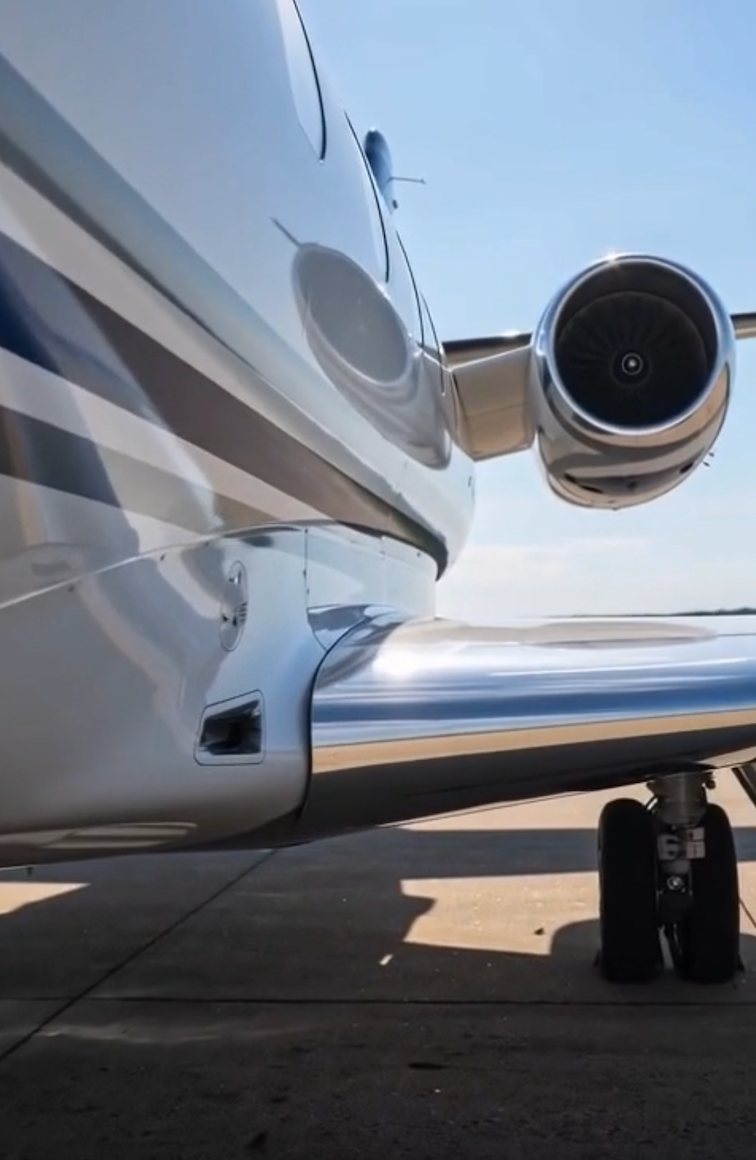 Close-up of jet engine, wing and reflective fuselage