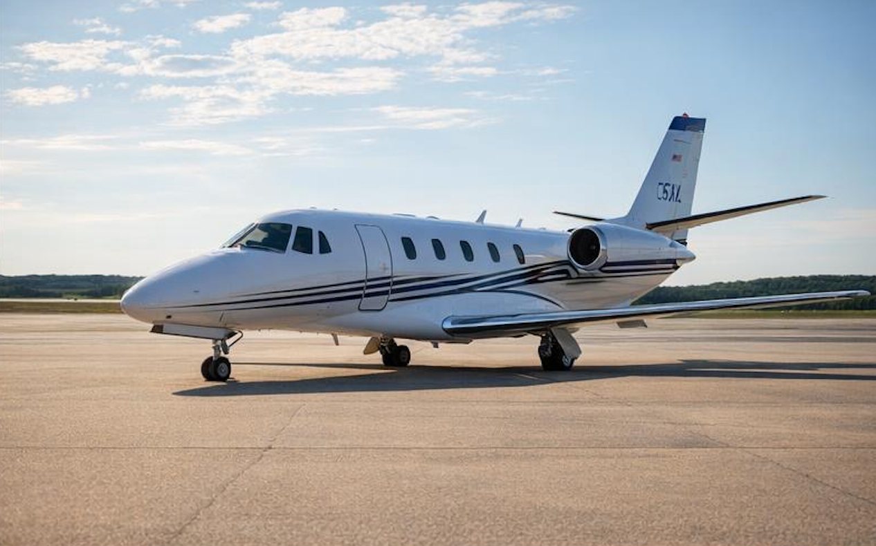 White business jet side profile in daylight