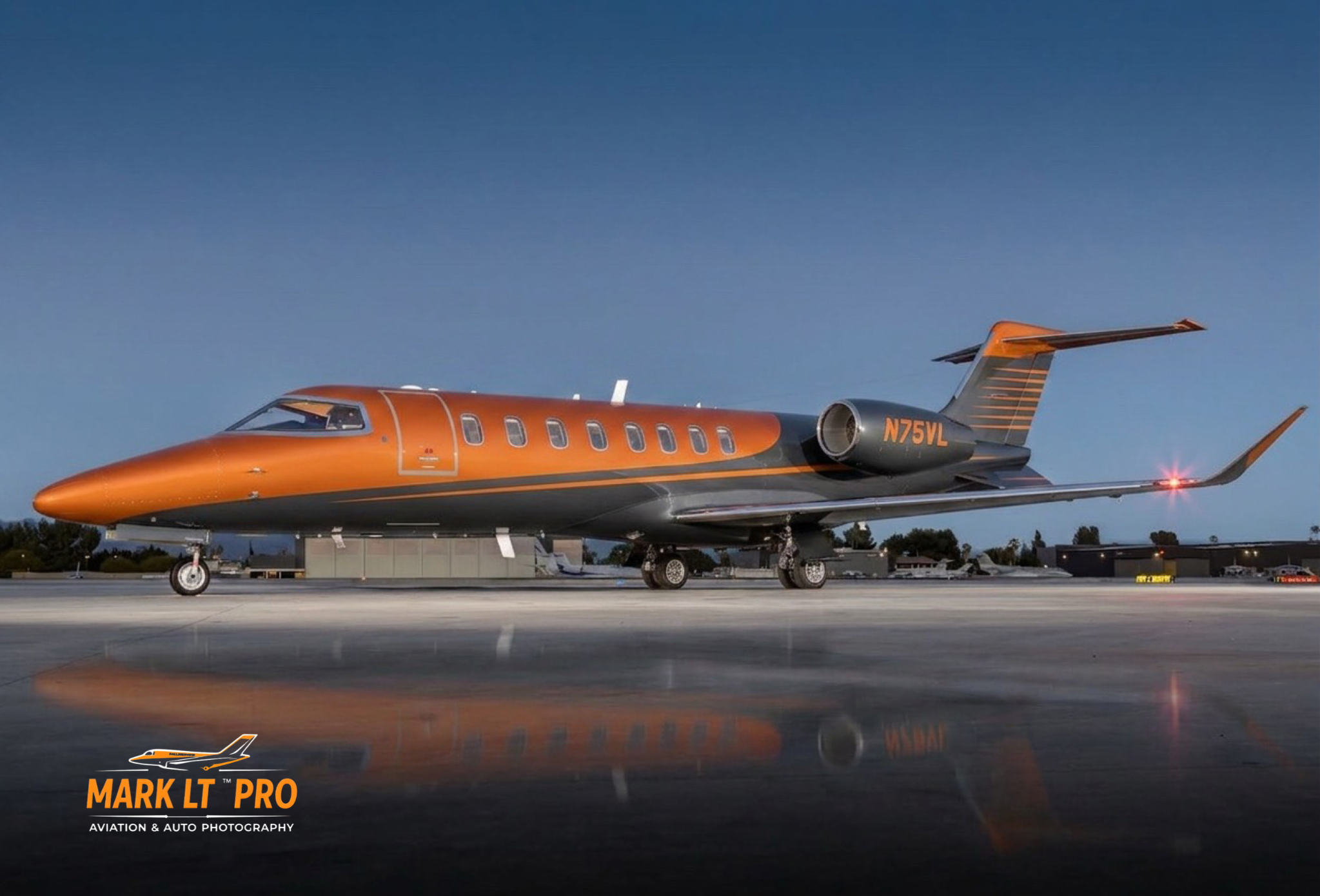 Learjet 75 photographed at twilight on a reflective ramp